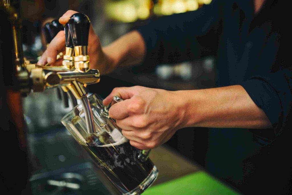 Slowly pour the chilled beer into the glass.